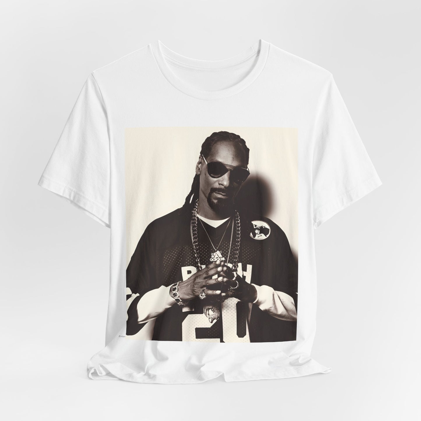 A black graphic t-shirt featuring a black and white, monochrome graphic or photo of Snoop Dogg in an OG style.