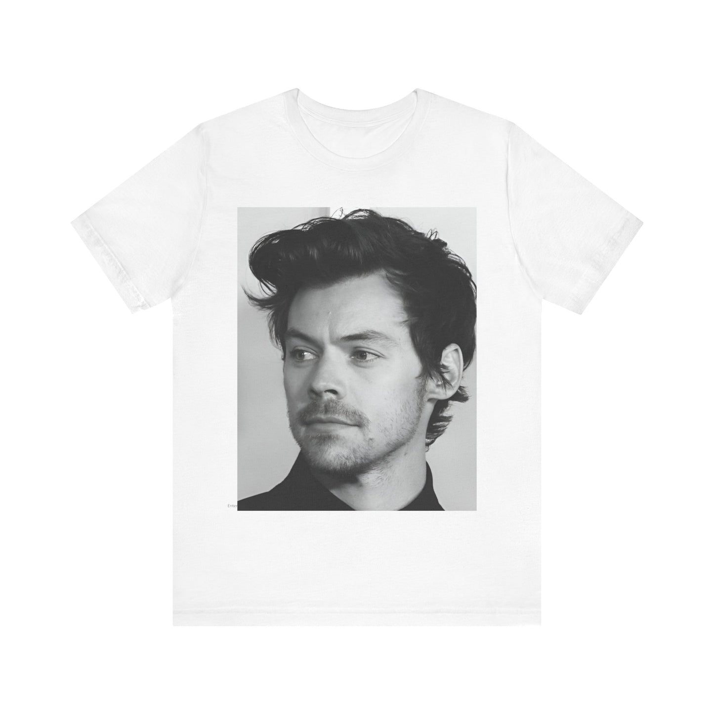 A black graphic t-shirt featuring a black and white, monochrome graphic or photo of Harry Styles.