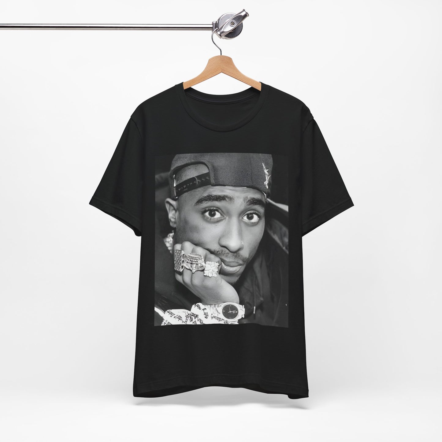 A black graphic t-shirt featuring a bold graphic of Tupac as a rap superstar.