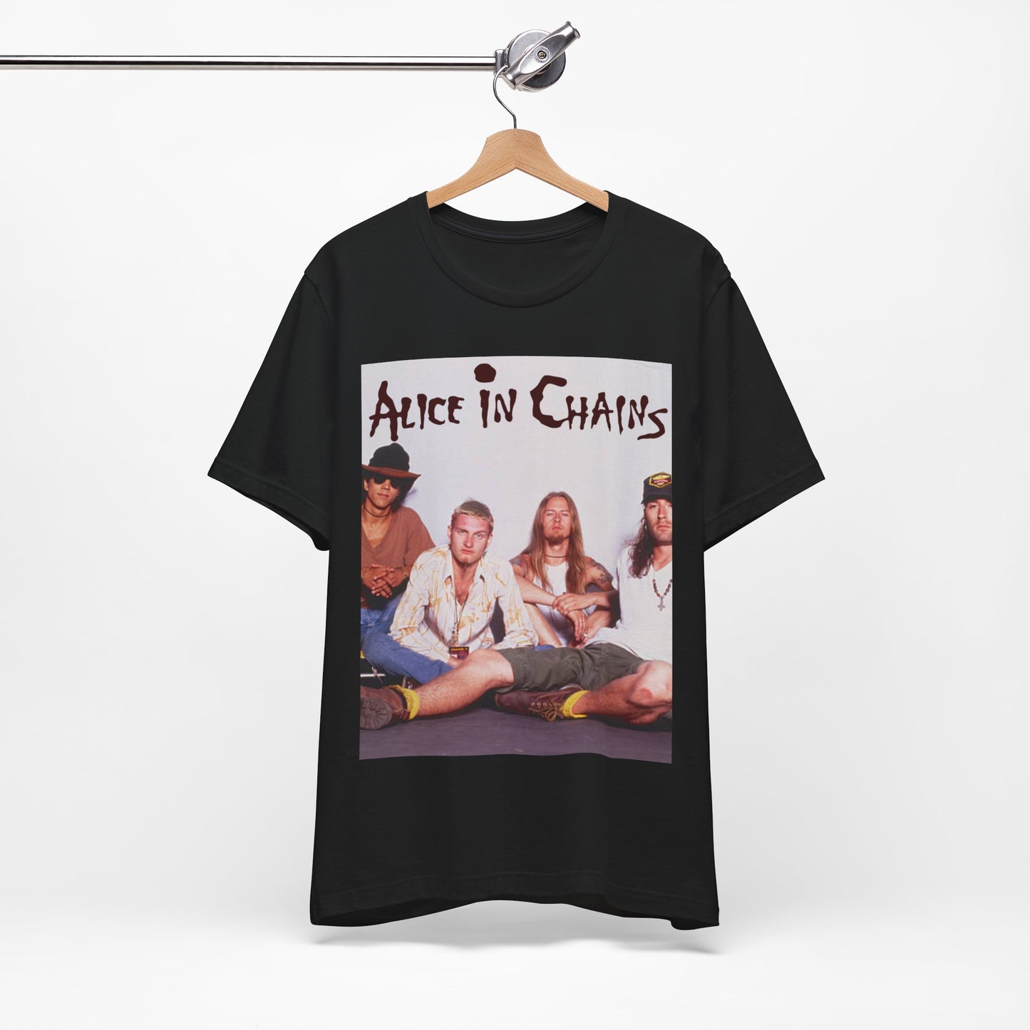 A black graphic t-shirt featuring a classic rock graphic of Alice In Chains from the 1990s, possibly with band members or stylized logo.
