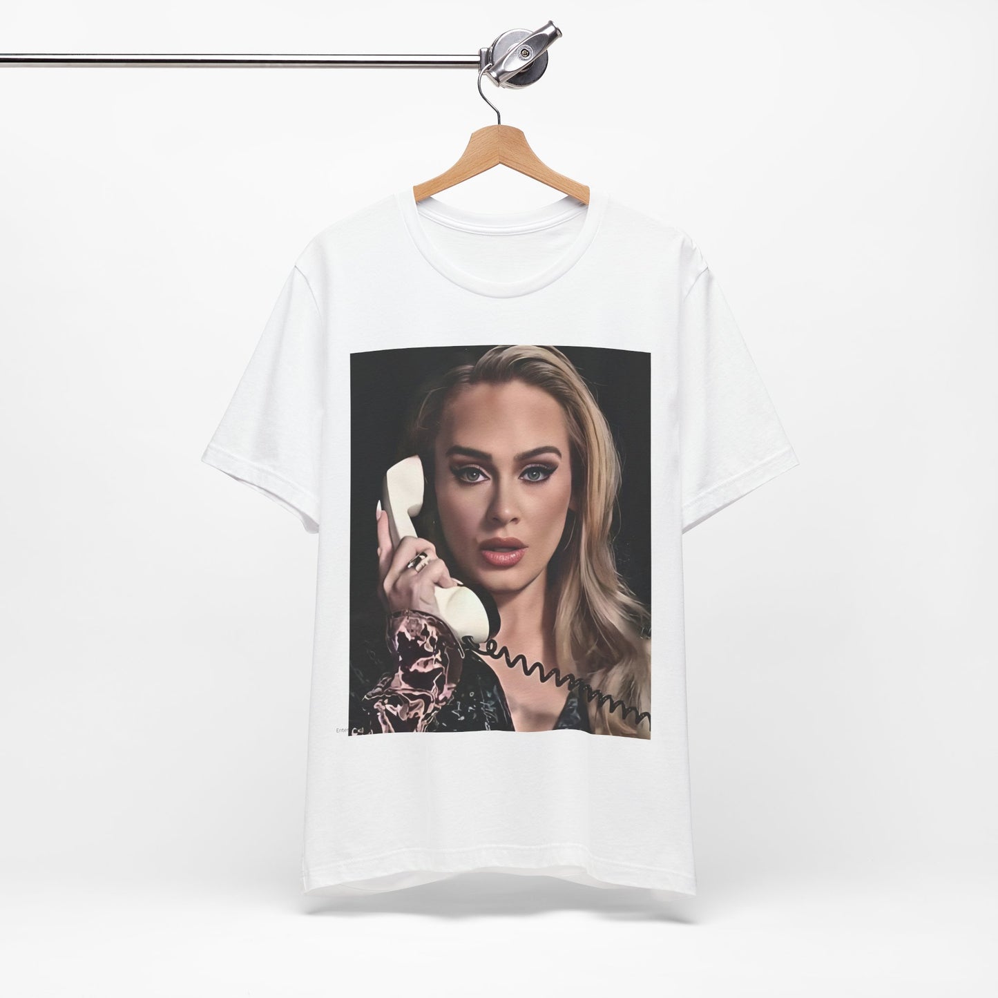 A black graphic t-shirt featuring a black and white candid photo of Adele with a phone to her ear, showing a thoughtful or emotional expression.
