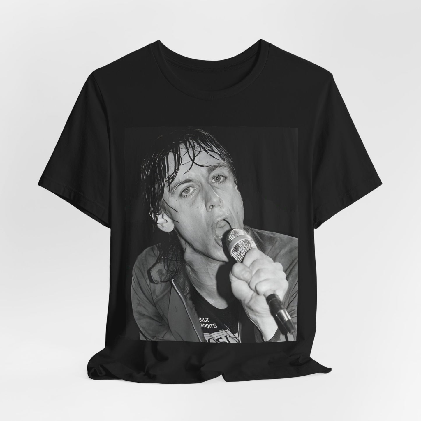 A black graphic t-shirt featuring a 70s graphic or photo of Iggy Pop performing in a wild concert.