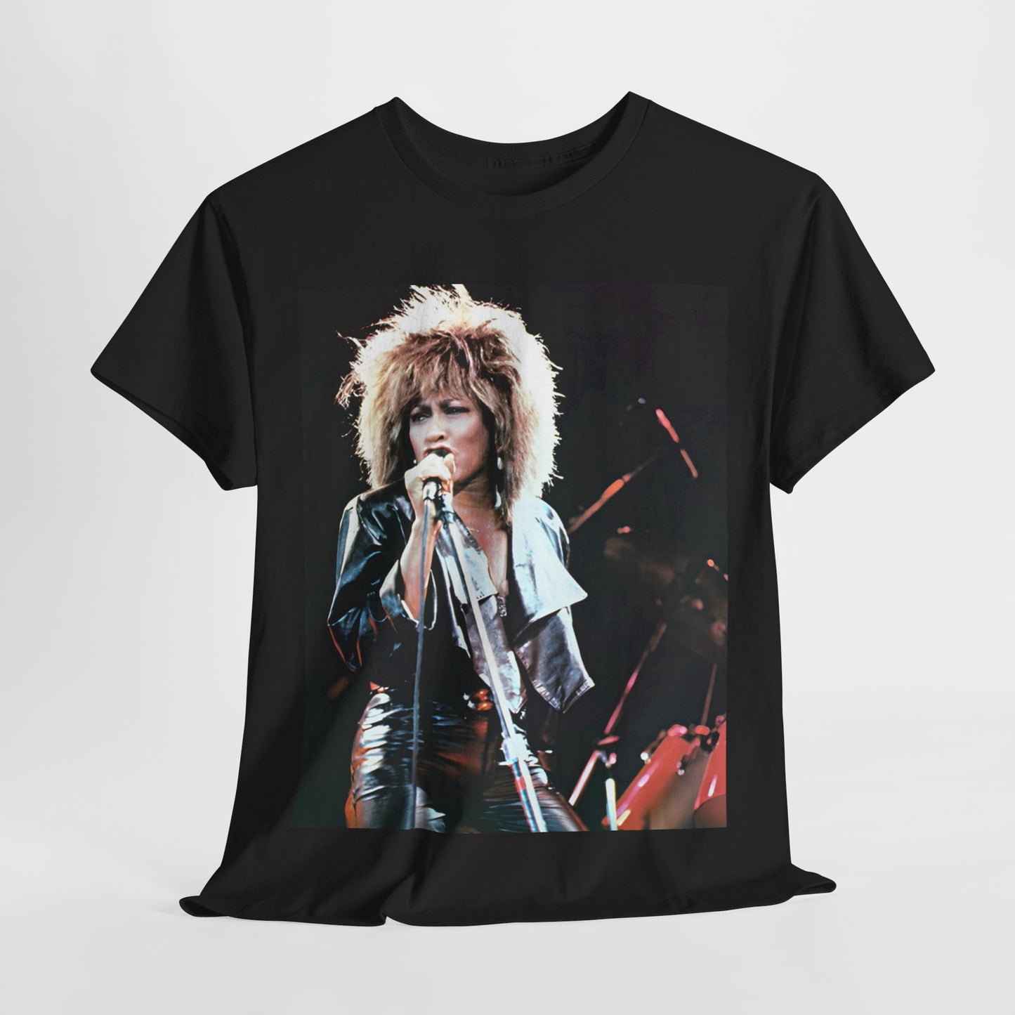 A black graphic t-shirt featuring a 90s graphic or photo of Tina Turner performing live on stage.