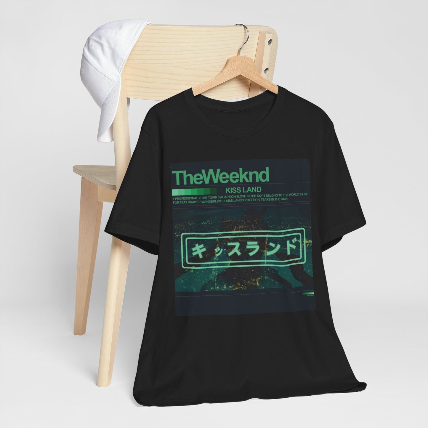 A black graphic t-shirt featuring a retro graphic related to The Weeknd's 'Kiss Land' album.