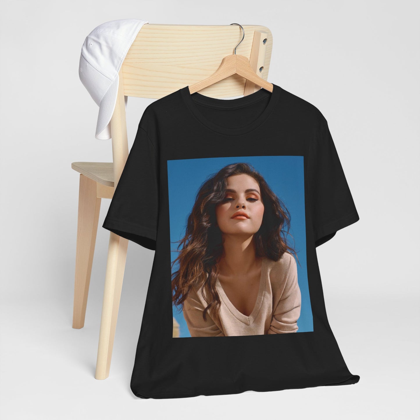 A black graphic t-shirt featuring a vintage pop icon graphic of Selena Gomez.