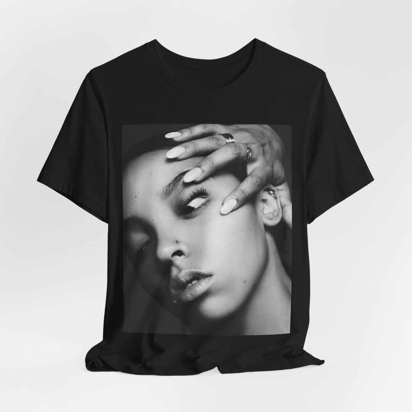 A black graphic t-shirt featuring a black and white, monochrome graphic or photo of Tinashe.