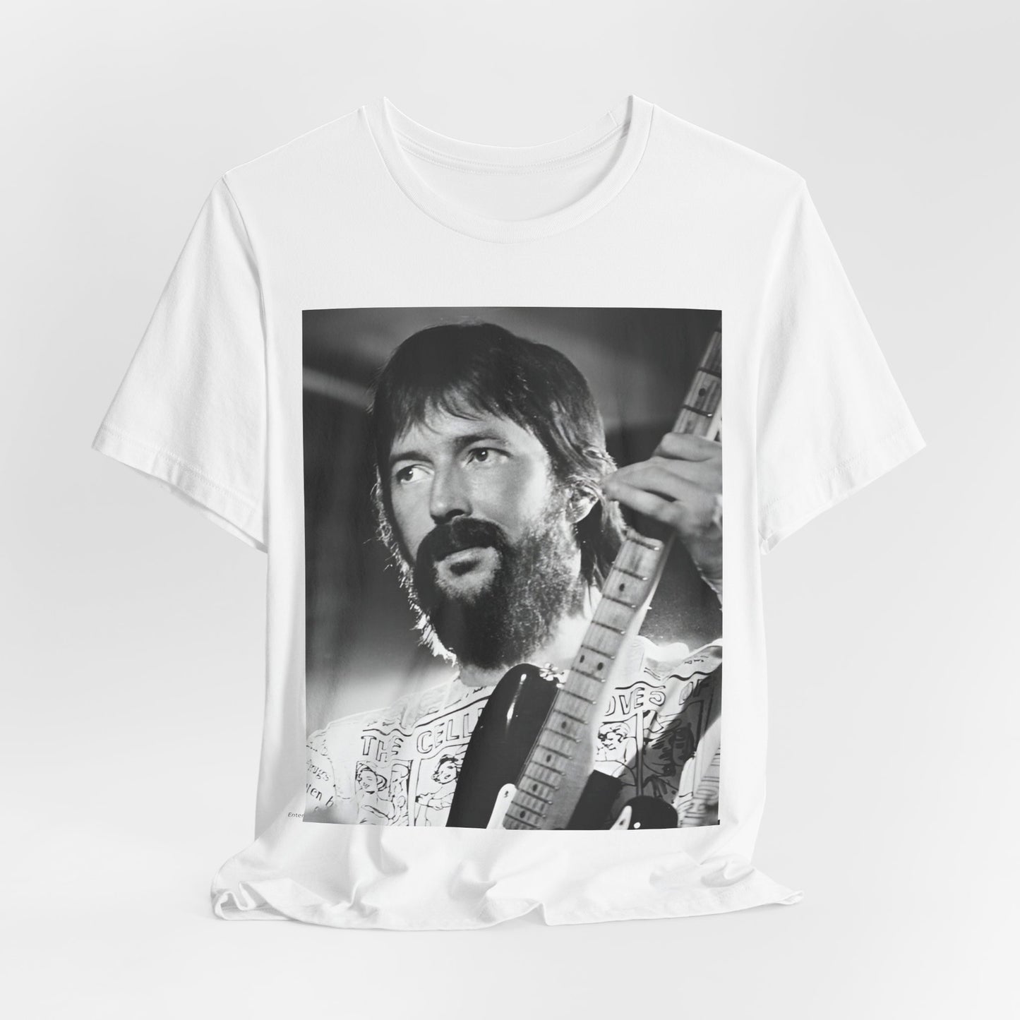 A black graphic t-shirt featuring a graphic of Eric Clapton as an authentic guitar god.