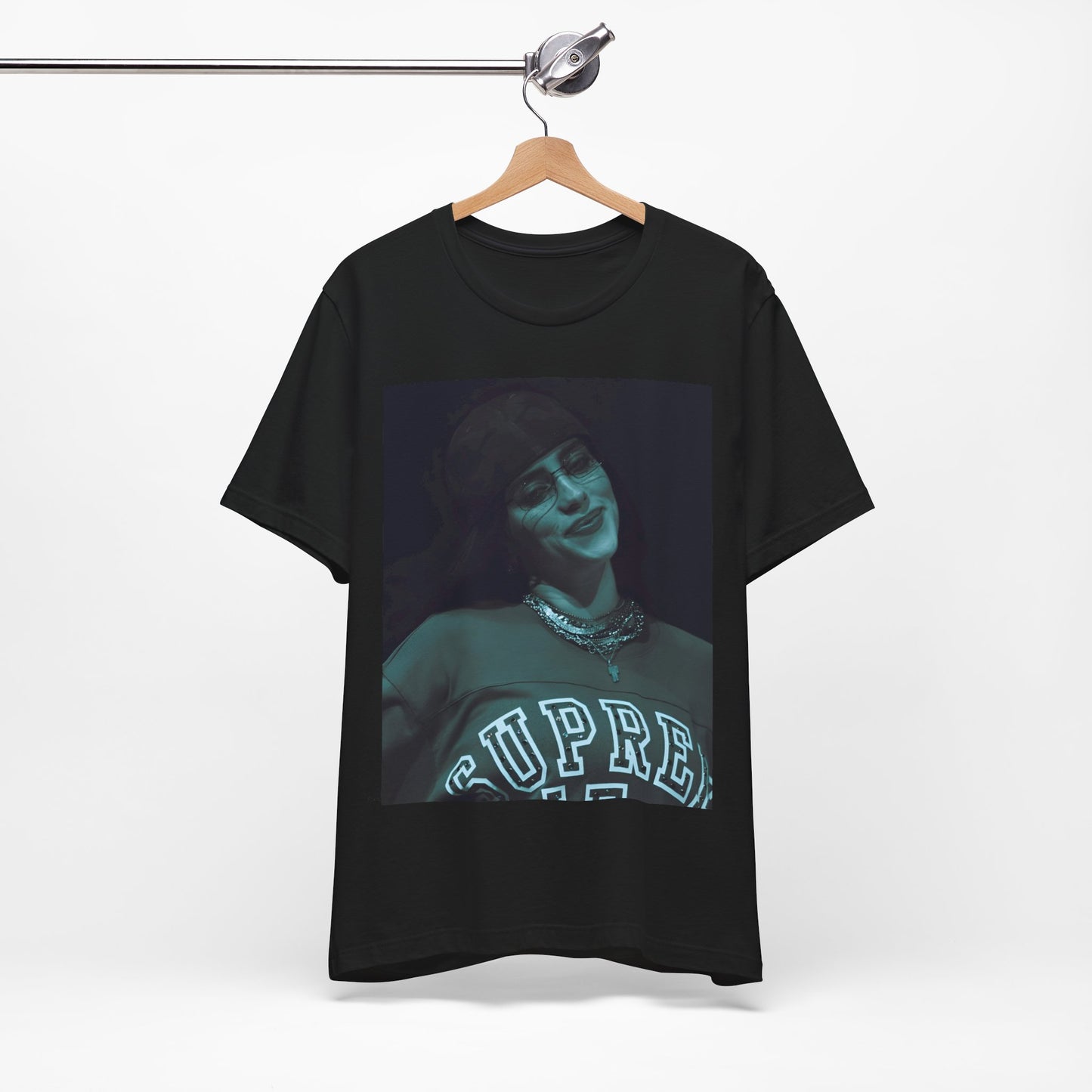 A powerful, close-up portrait of Billie Eilish with a direct and intense stare, printed on a graphic t-shirt.