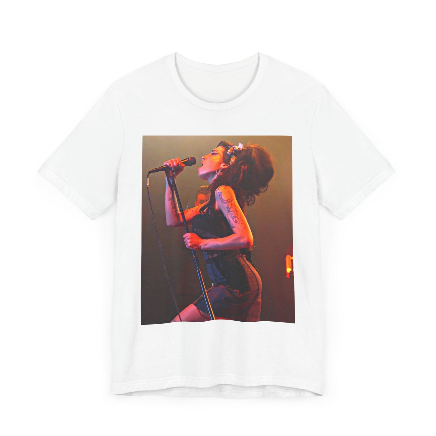 A black graphic t-shirt featuring a dynamic photo of Amy Winehouse performing live, with elements suggesting her 'Back to Black' era.
