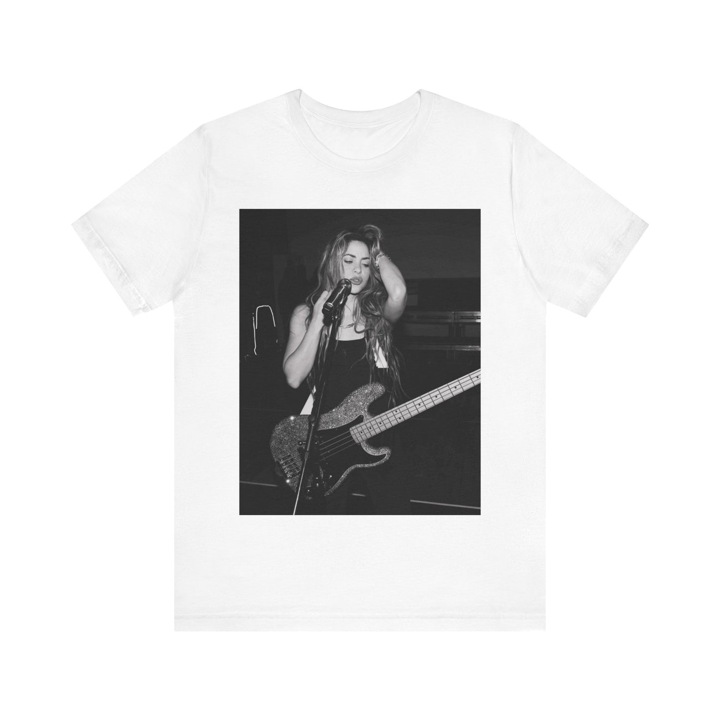 A black graphic t-shirt featuring a black and white graphic or photo of Shakira playing guitar live.