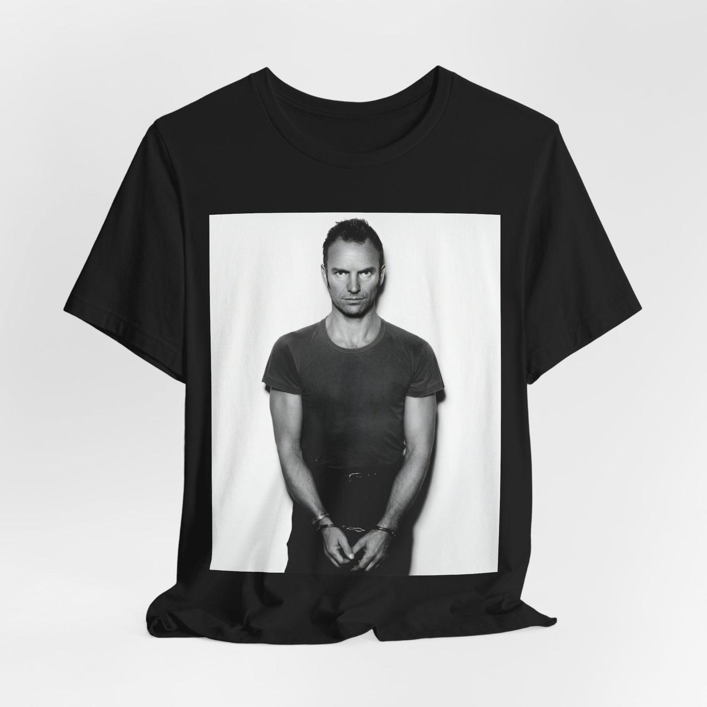 A black graphic t-shirt featuring a black and white portrait photo of Sting.