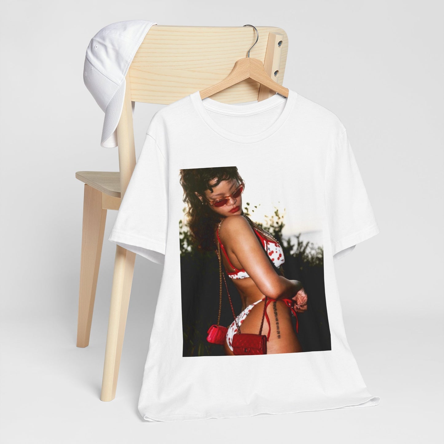 A black graphic t-shirt featuring a photo graphic of Rihanna in a bikini.