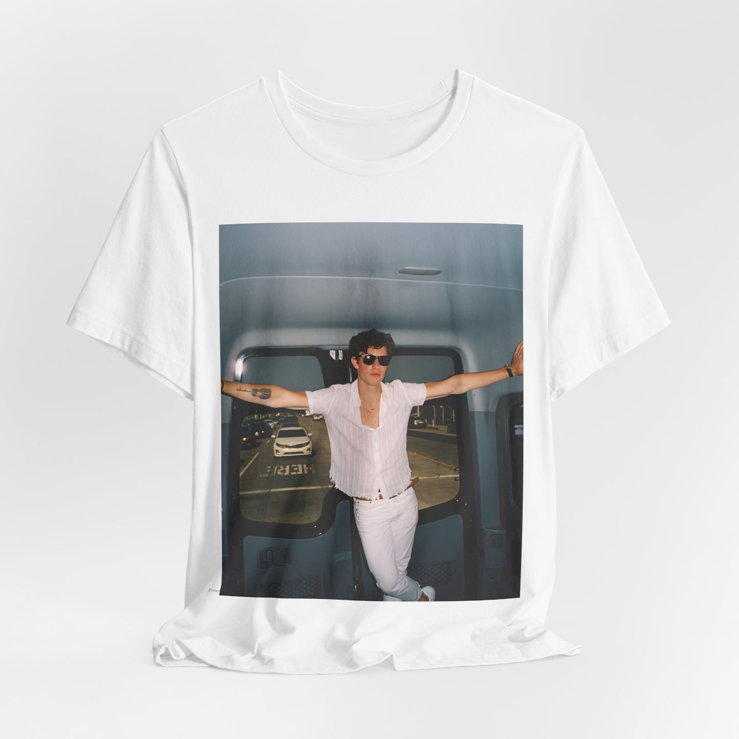 A black graphic t-shirt featuring a graphic of Shawn Mendes with a classic confident look.