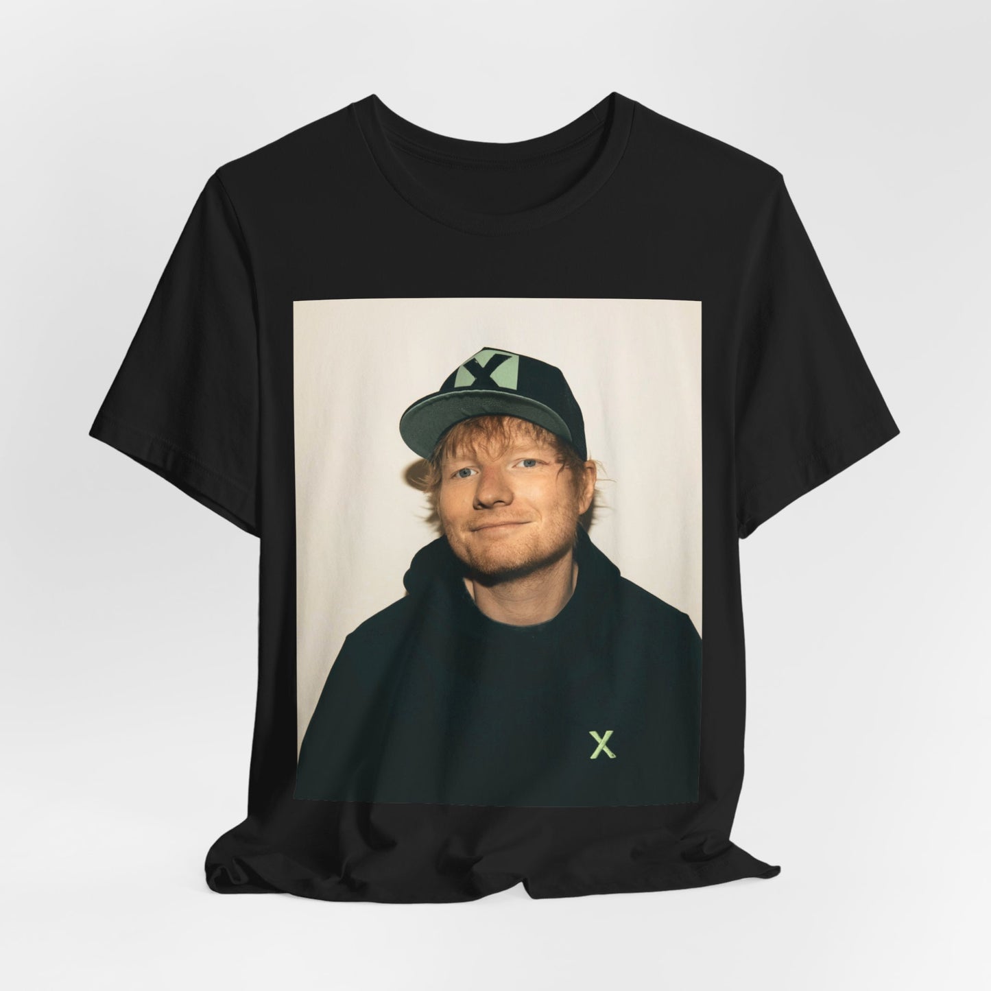 A black graphic t-shirt featuring a glamorous graphic of Ed Sheeran as a global tour icon.