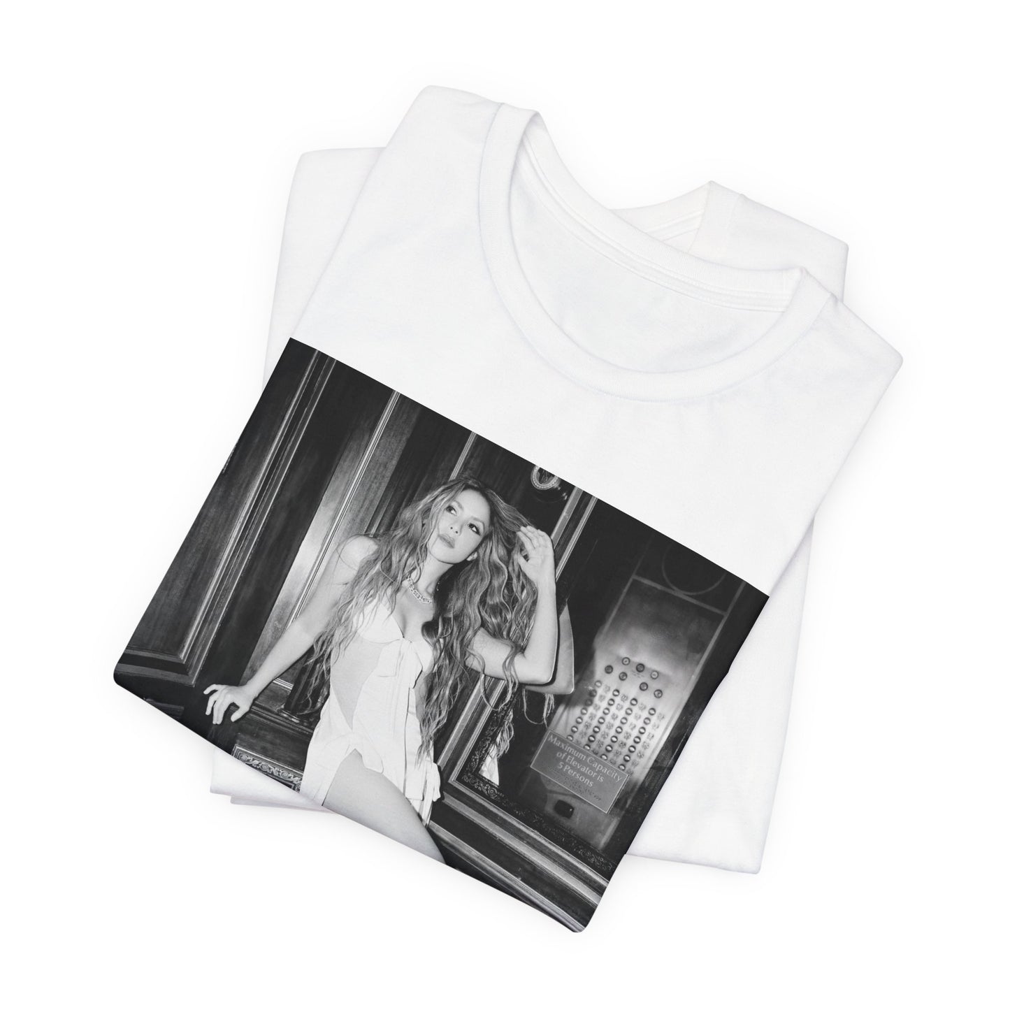 A black graphic t-shirt featuring a retro black and white monochrome graphic or photo of Shakira.