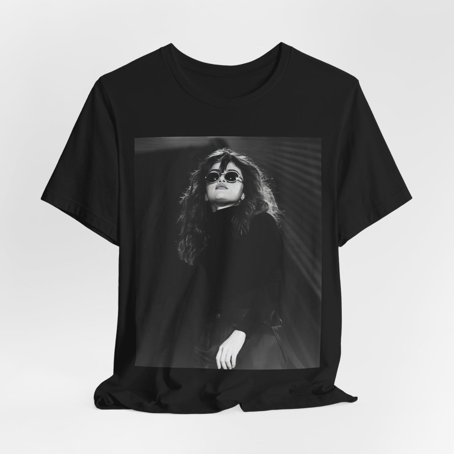 A black graphic t-shirt featuring a black and white, monochrome graphic or photo of Selena Gomez.