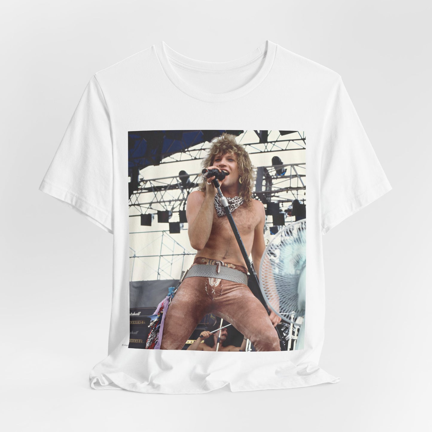 A black graphic t-shirt featuring a dynamic graphic or photo of Bon Jovi performing live on stage with a fierce intensity.