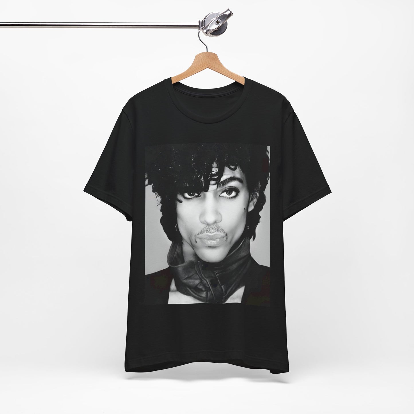 A black graphic t-shirt featuring a black and white photo portrait of Prince.