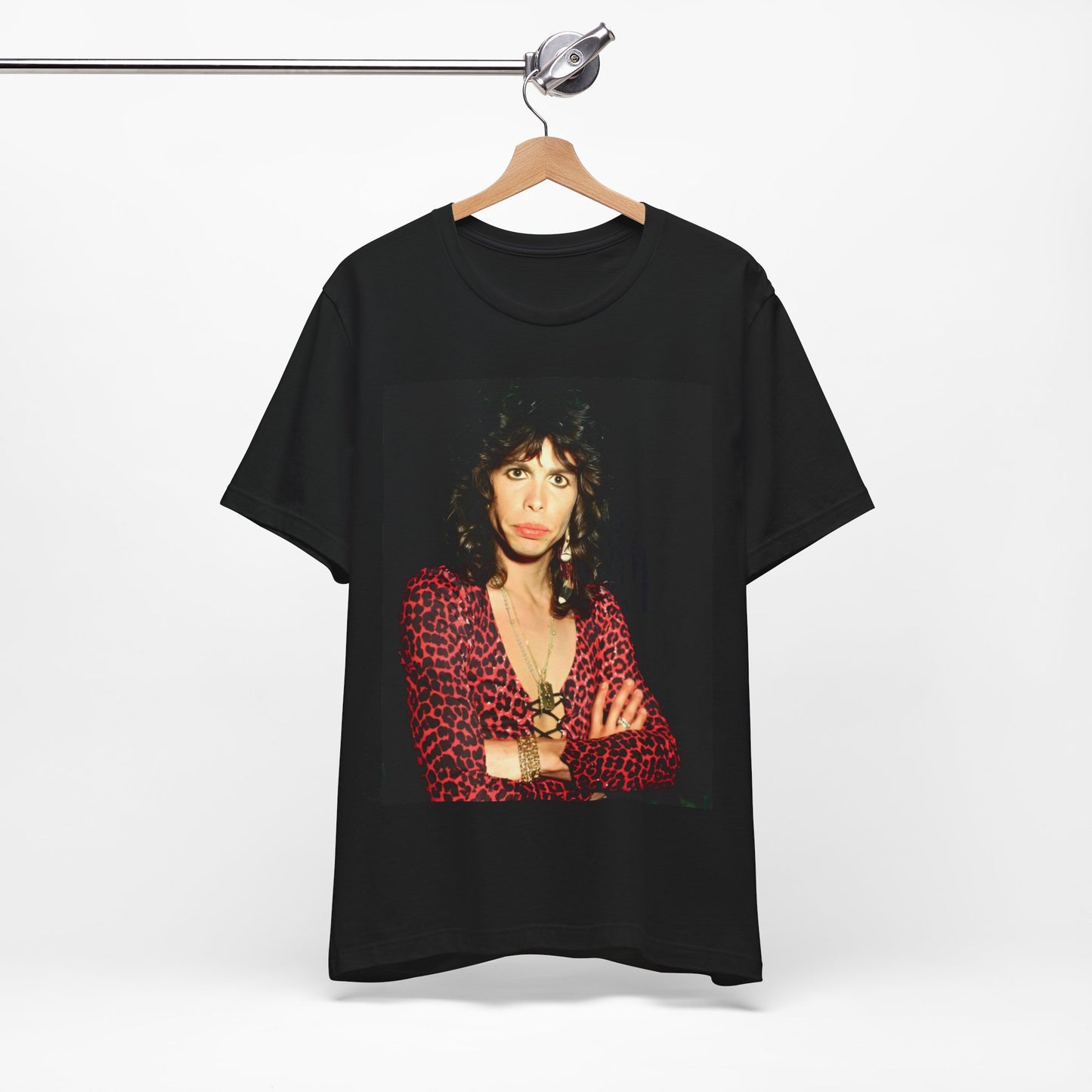 A black graphic t-shirt featuring a vintage 70s-inspired design with Aerosmith branding, incorporating a prominent leopard print pattern.