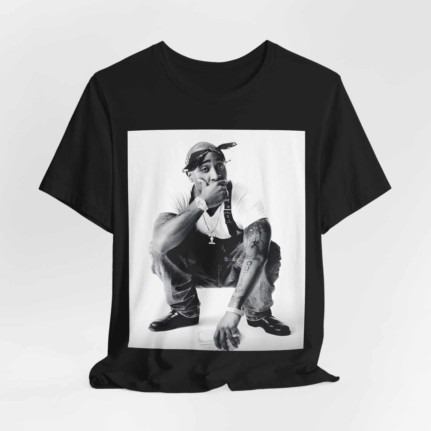 A black graphic t-shirt featuring a graphic of Tupac with a conscious rap vibe.