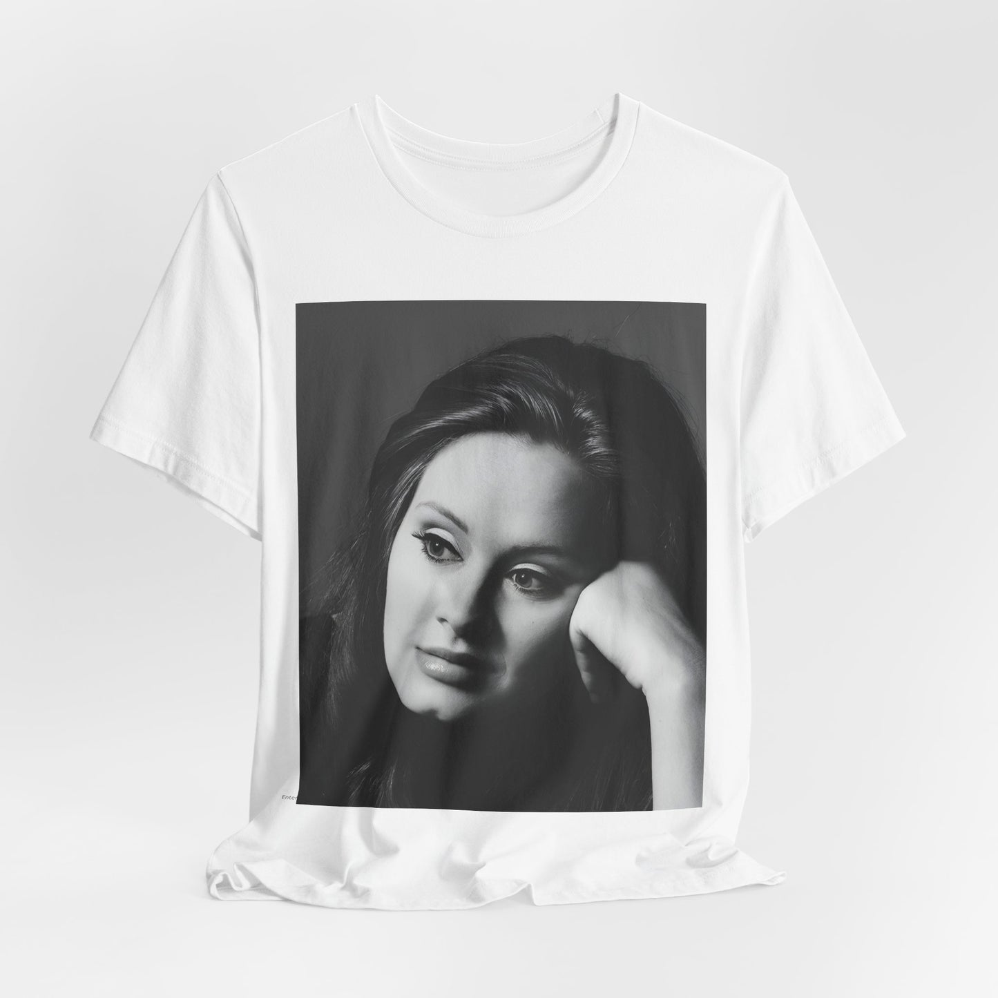 A black graphic t-shirt featuring a vintage-style black and white studio portrait of Adele, showing her with a poised and elegant expression.
