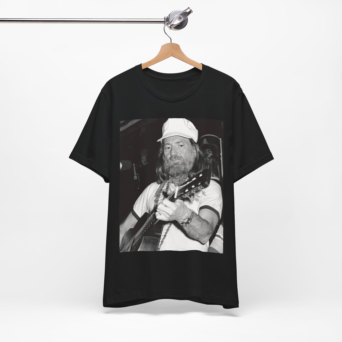 A black graphic t-shirt featuring a 70s cool free spirit graphic of Willie Nelson.