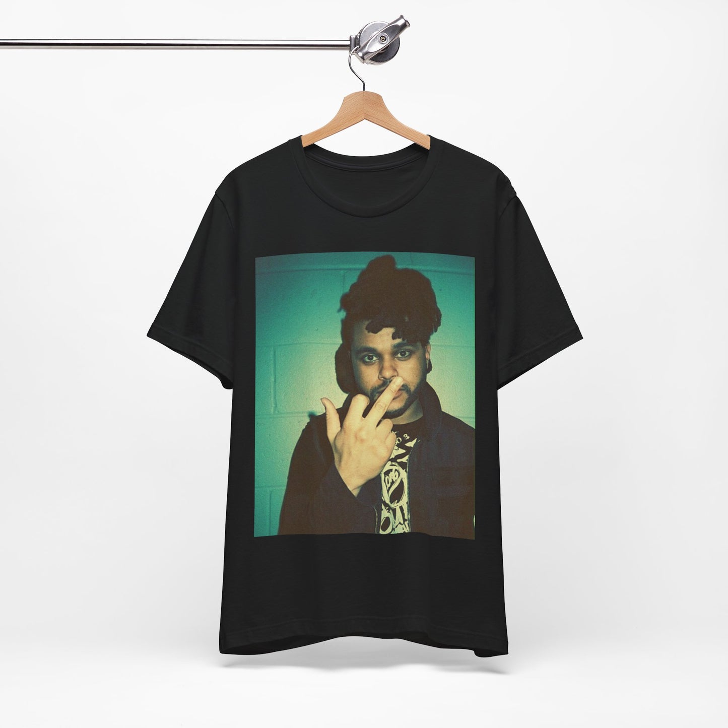 A black graphic t-shirt featuring a graphic of The Weeknd making the middle finger gesture.