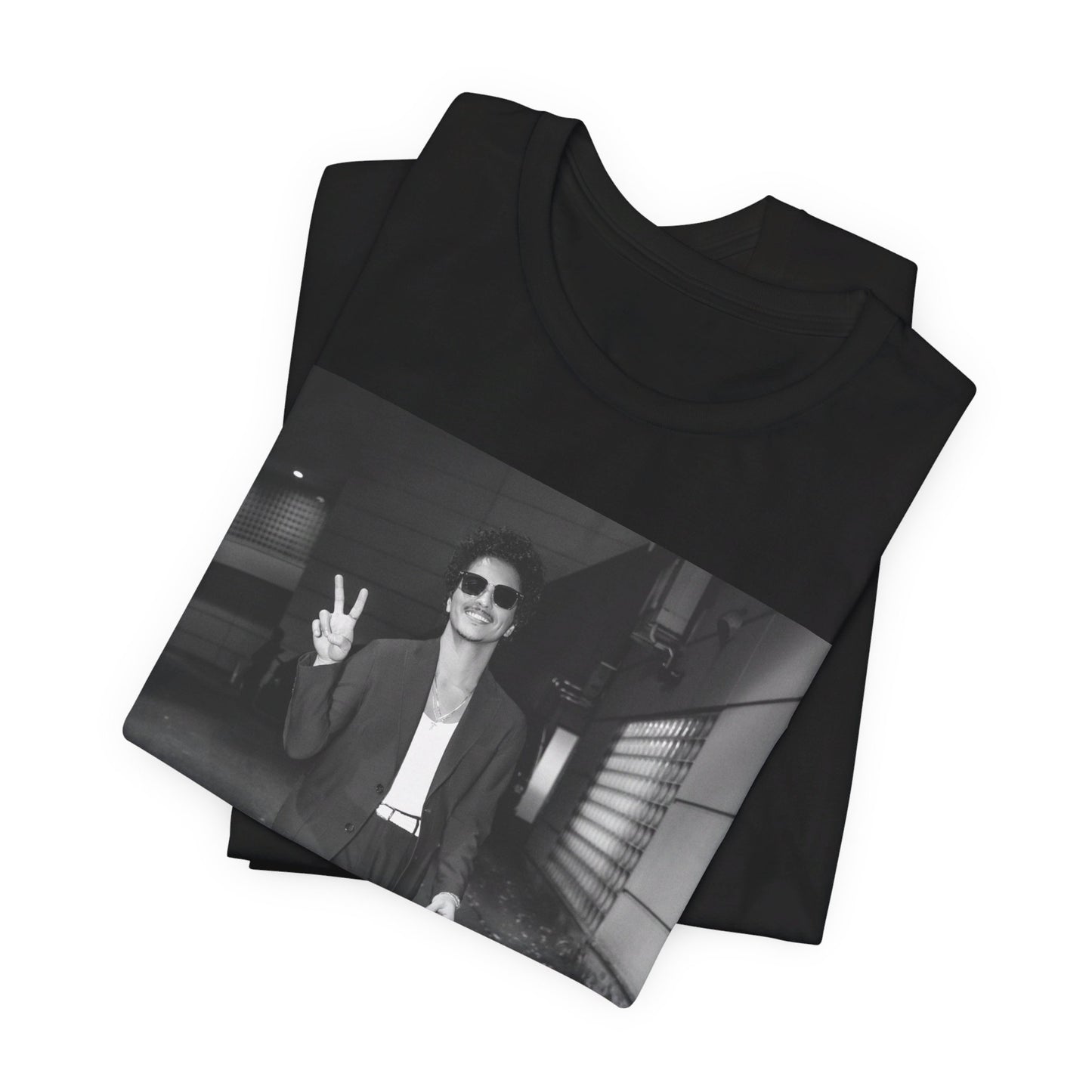 A black graphic t-shirt featuring a black and white graphic or photo of Bruno Mars in a backstage setting.