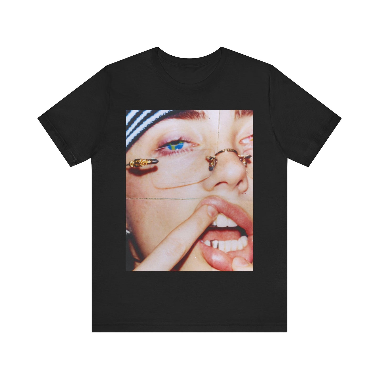 A direct, unfiltered, close-up portrait of Billie Eilish with dark hair looking straight at the camera, printed on a t-shirt.