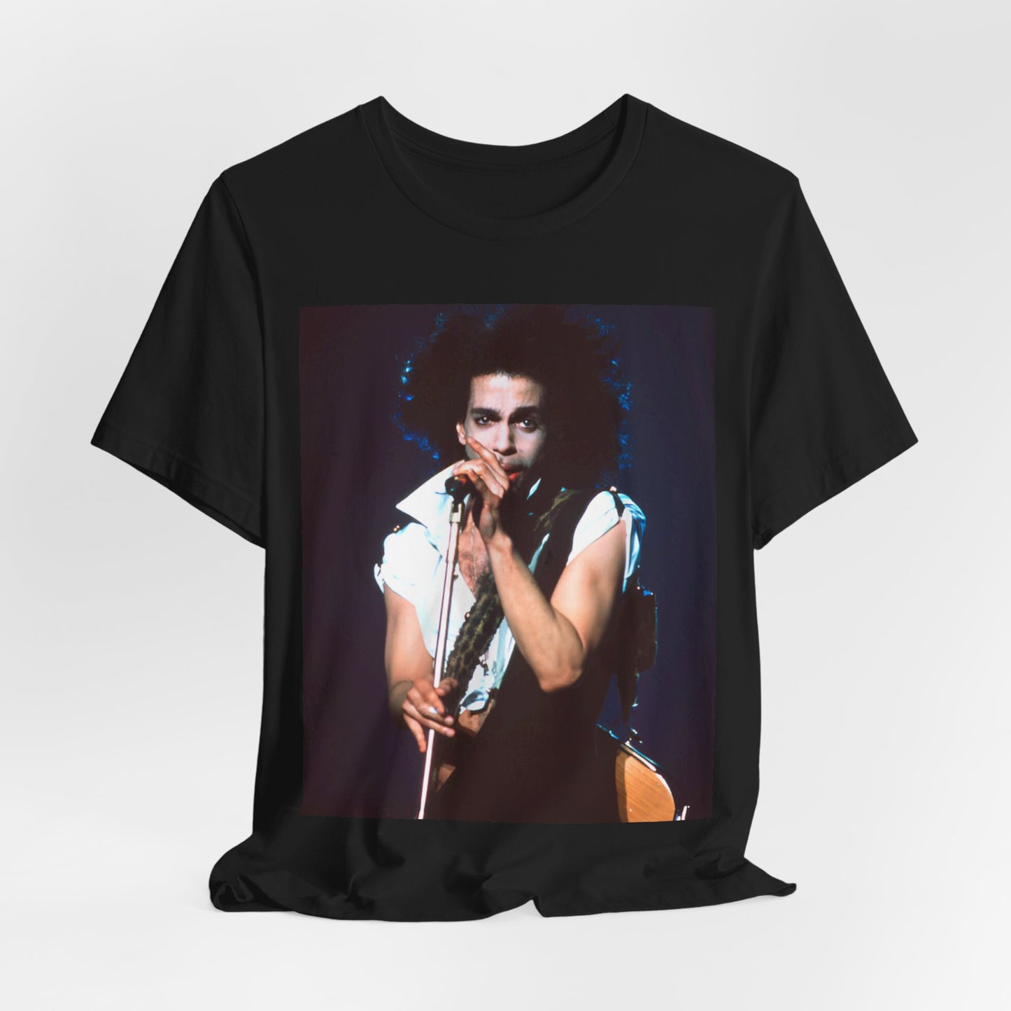 A black graphic t-shirt featuring a 90s live performance graphic of Prince.