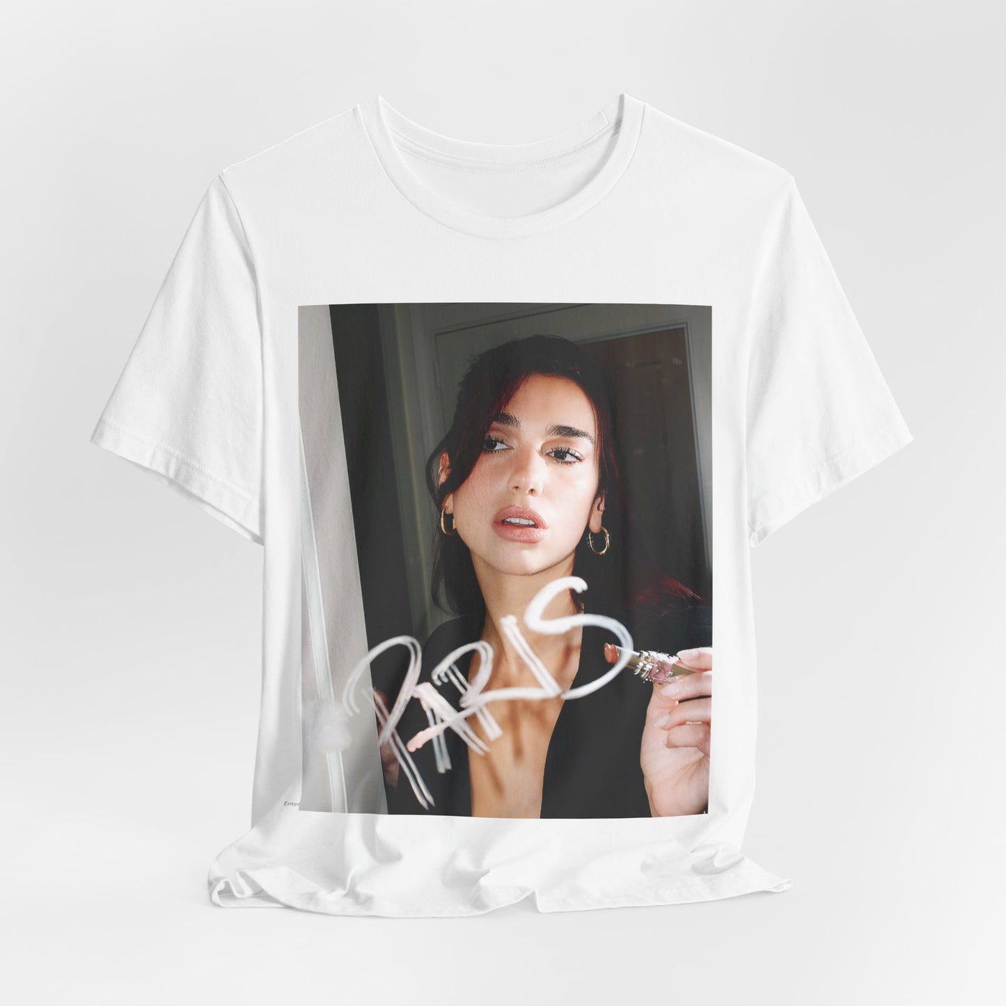A black graphic t-shirt featuring a graphic of Dua Lipa, possibly with Parisian elements or a 'Paris' theme.