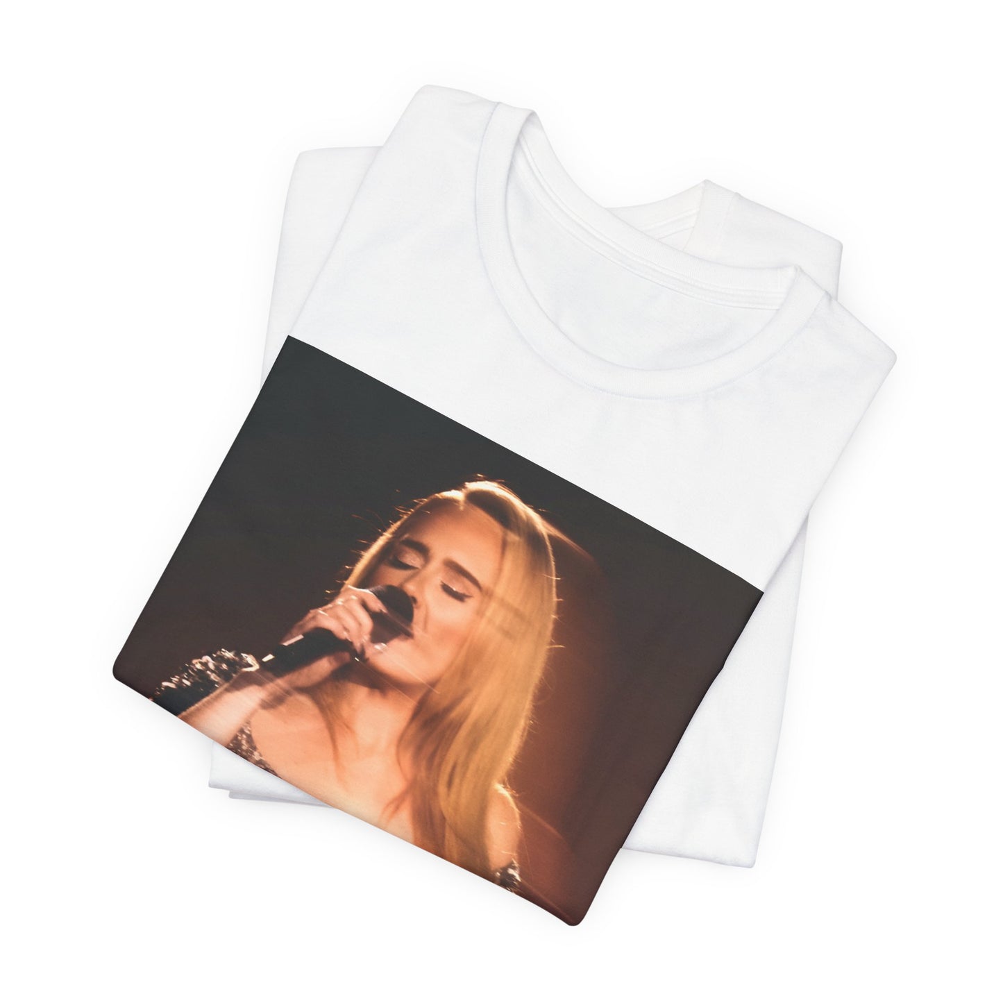 A black graphic t-shirt featuring a stylized image or photo of Adele related to her Las Vegas residency, possibly with elements of stage lighting or show branding.