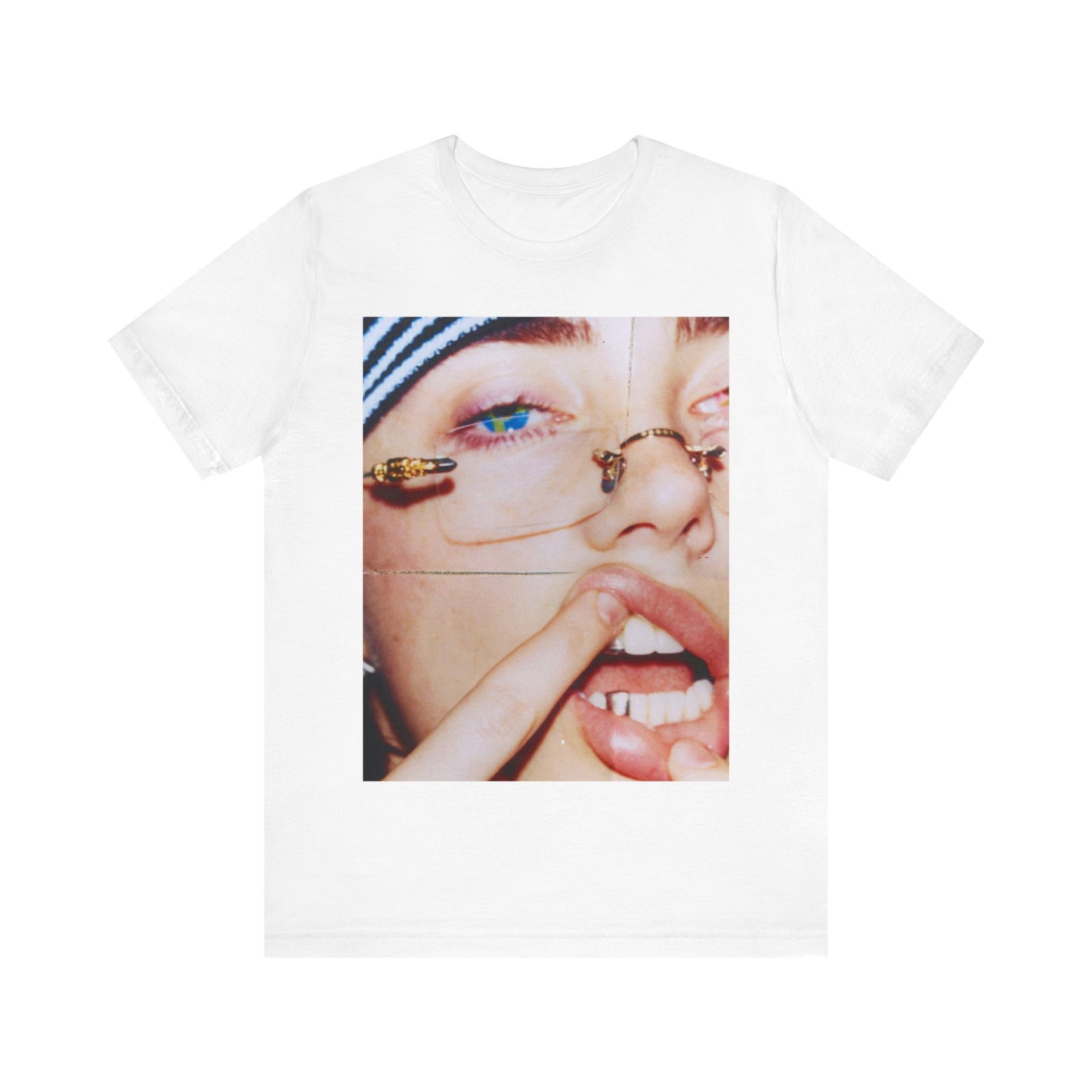 A direct, unfiltered, close-up portrait of Billie Eilish with dark hair looking straight at the camera, printed on a t-shirt.