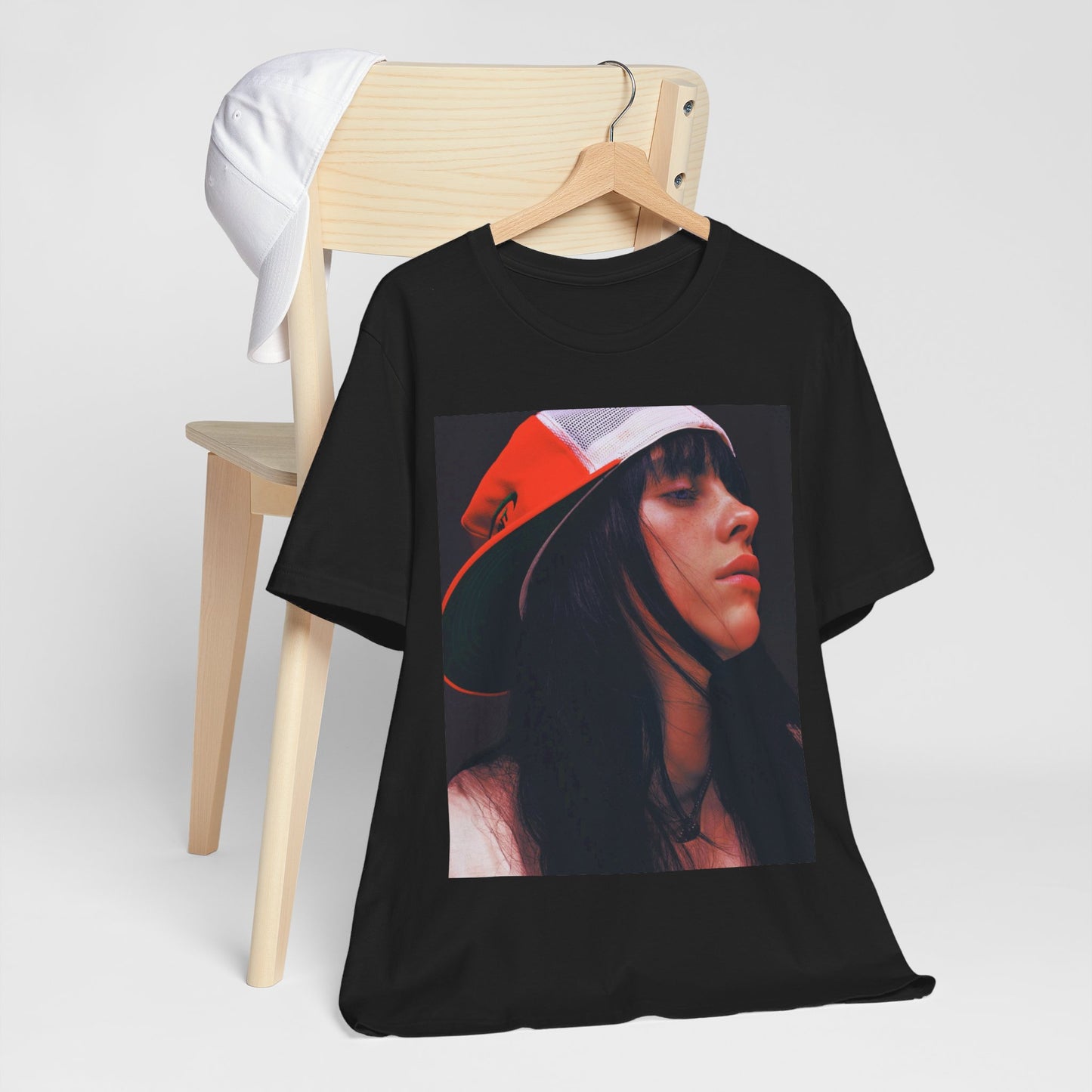 A graphic t-shirt featuring the name 'Billie Eilish' in a raw, urban street-style font.