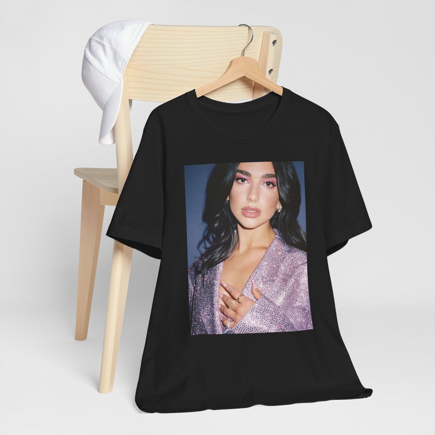 A black graphic t-shirt featuring a retro photo of Dua Lipa as a dance floor queen.