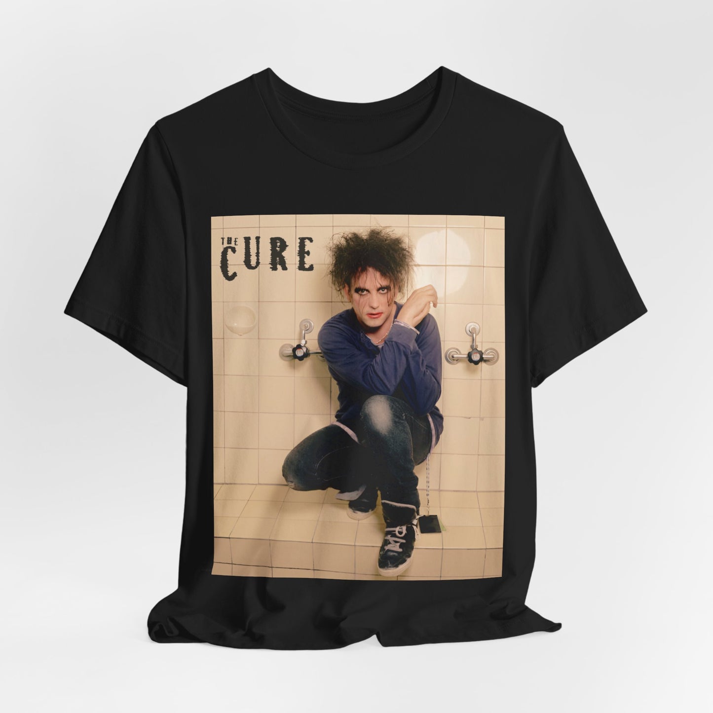 A black graphic t-shirt featuring a graphic related to The Cure's 'Friday I'm In Love' song or era.