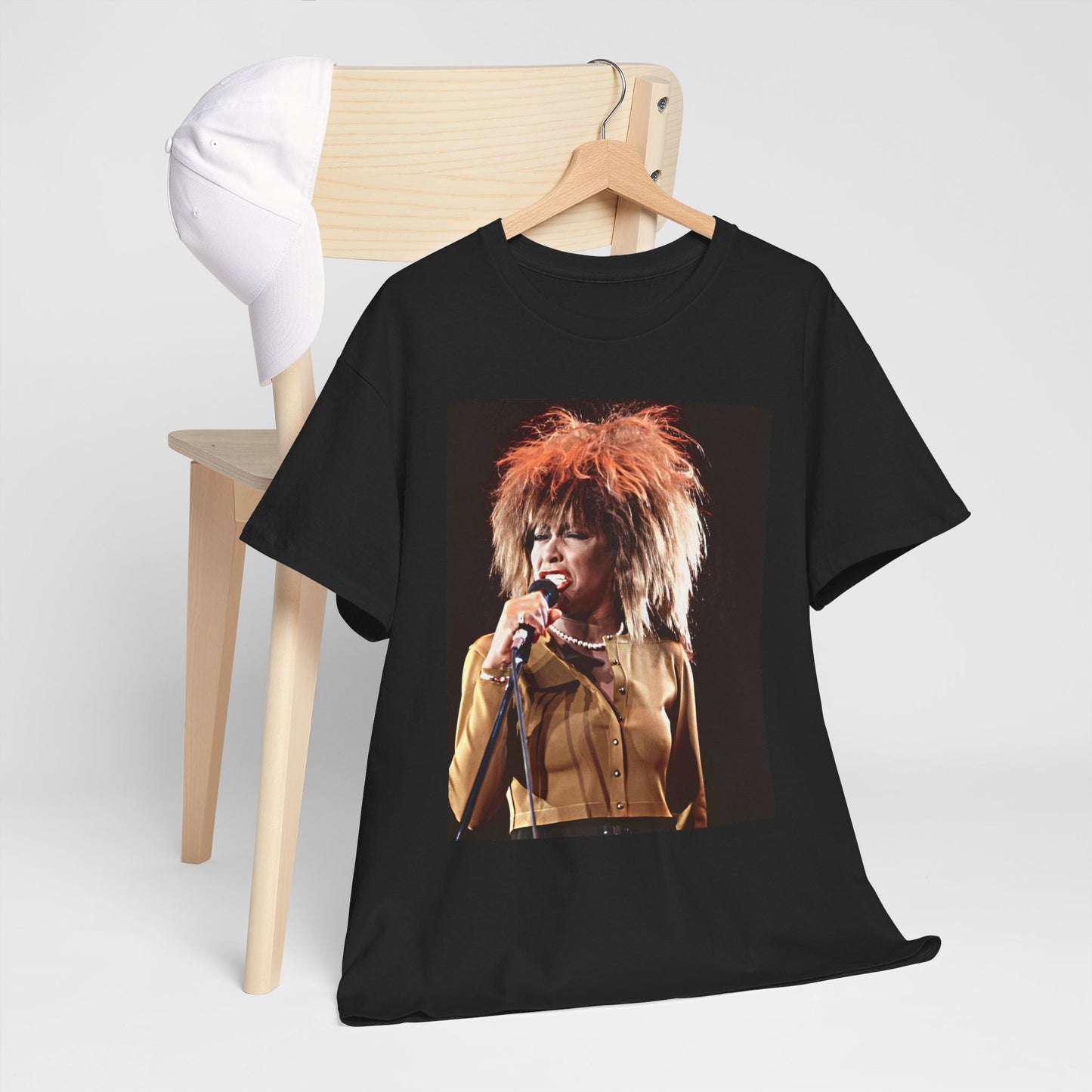 A black graphic t-shirt featuring a graphic of Tina Turner as a legendary rock icon.