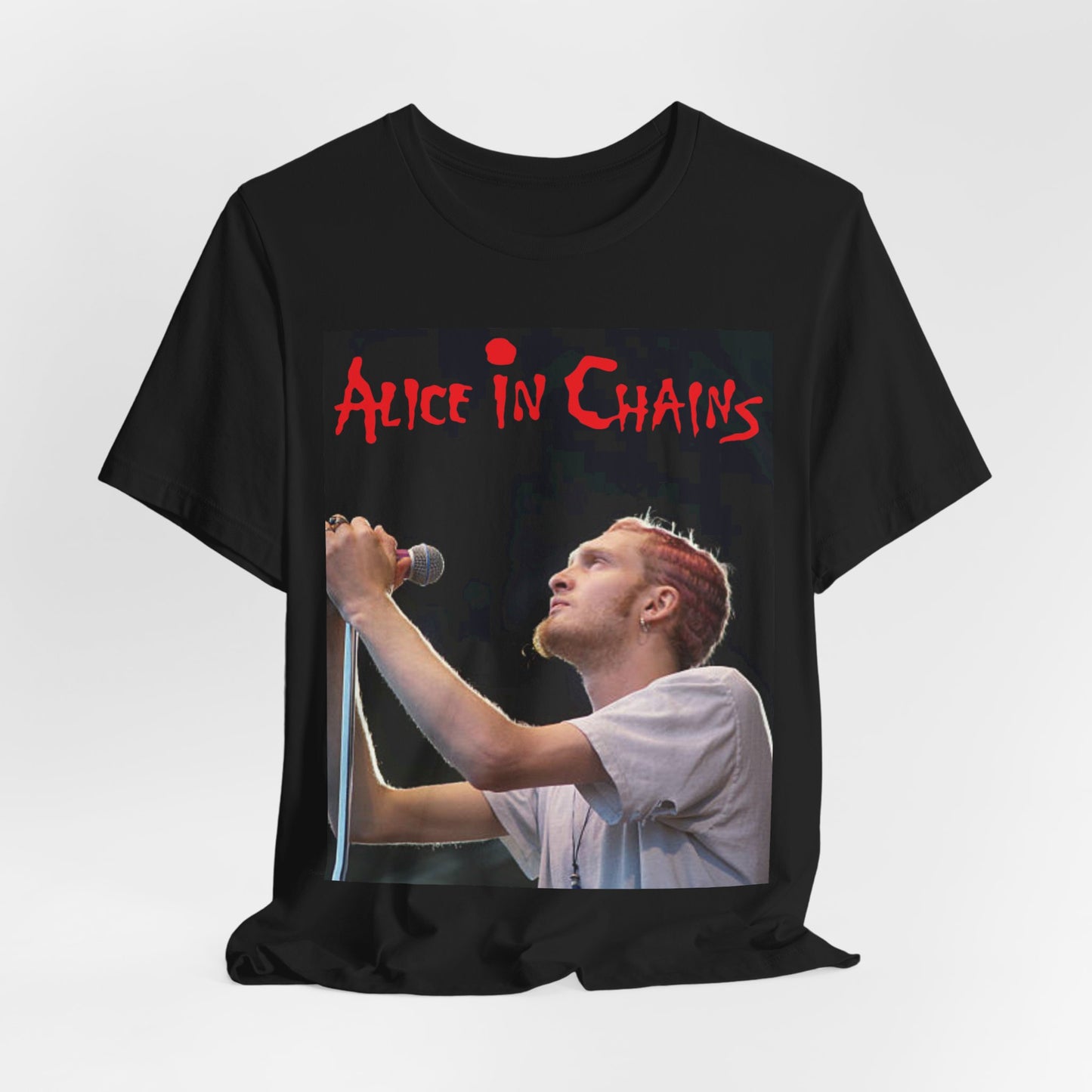 A black graphic t-shirt featuring the Alice In Chains logo in red, in a 90s grunge style.