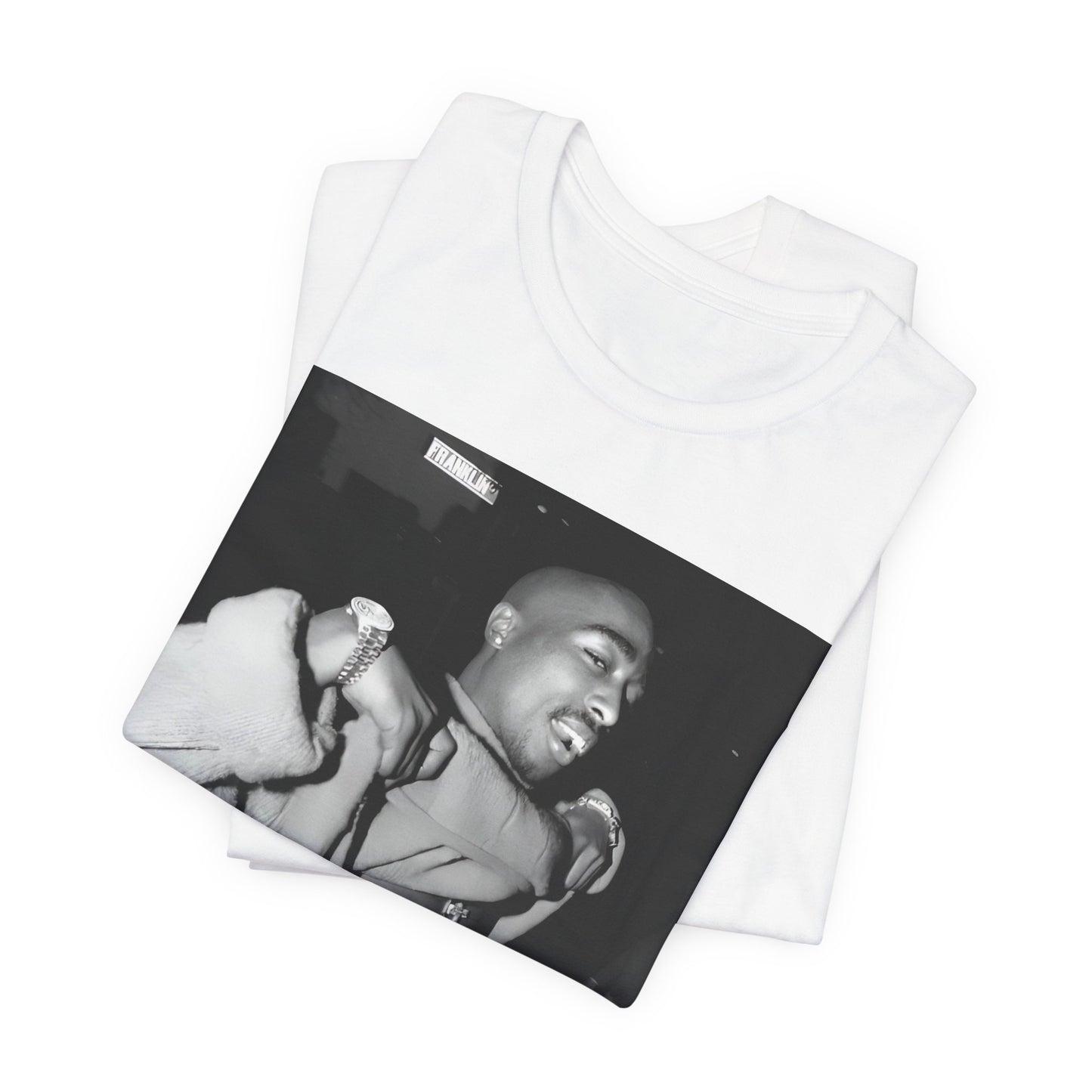 A black graphic t-shirt featuring a vintage hip hop icon graphic of Tupac.
