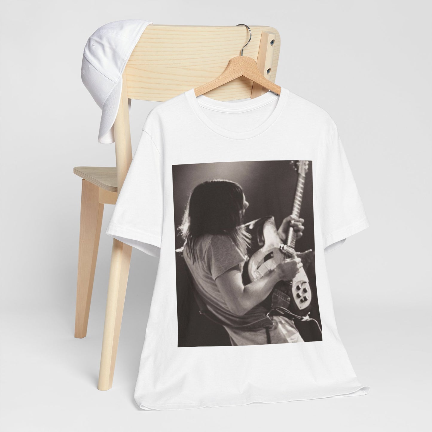 A black graphic t-shirt featuring a black and white graphic or photo of Tame Impala performing live on stage.