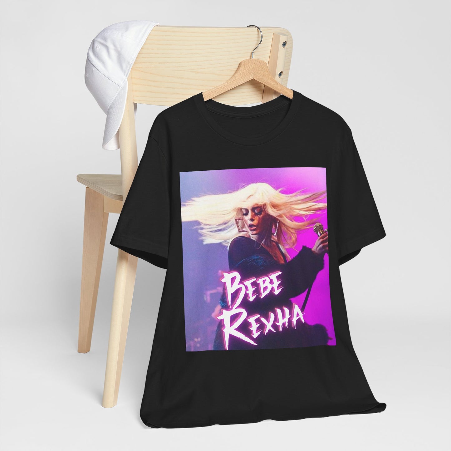 A black graphic t-shirt featuring a dynamic graphic or photo of Bebe Rexha performing live in concert.