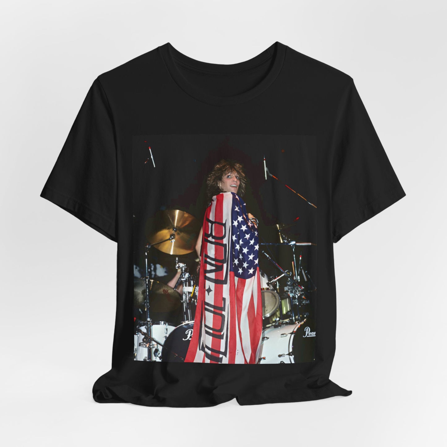 A black graphic t-shirt featuring a graphic of Bon Jovi performing on stage with an American flag as a backdrop.