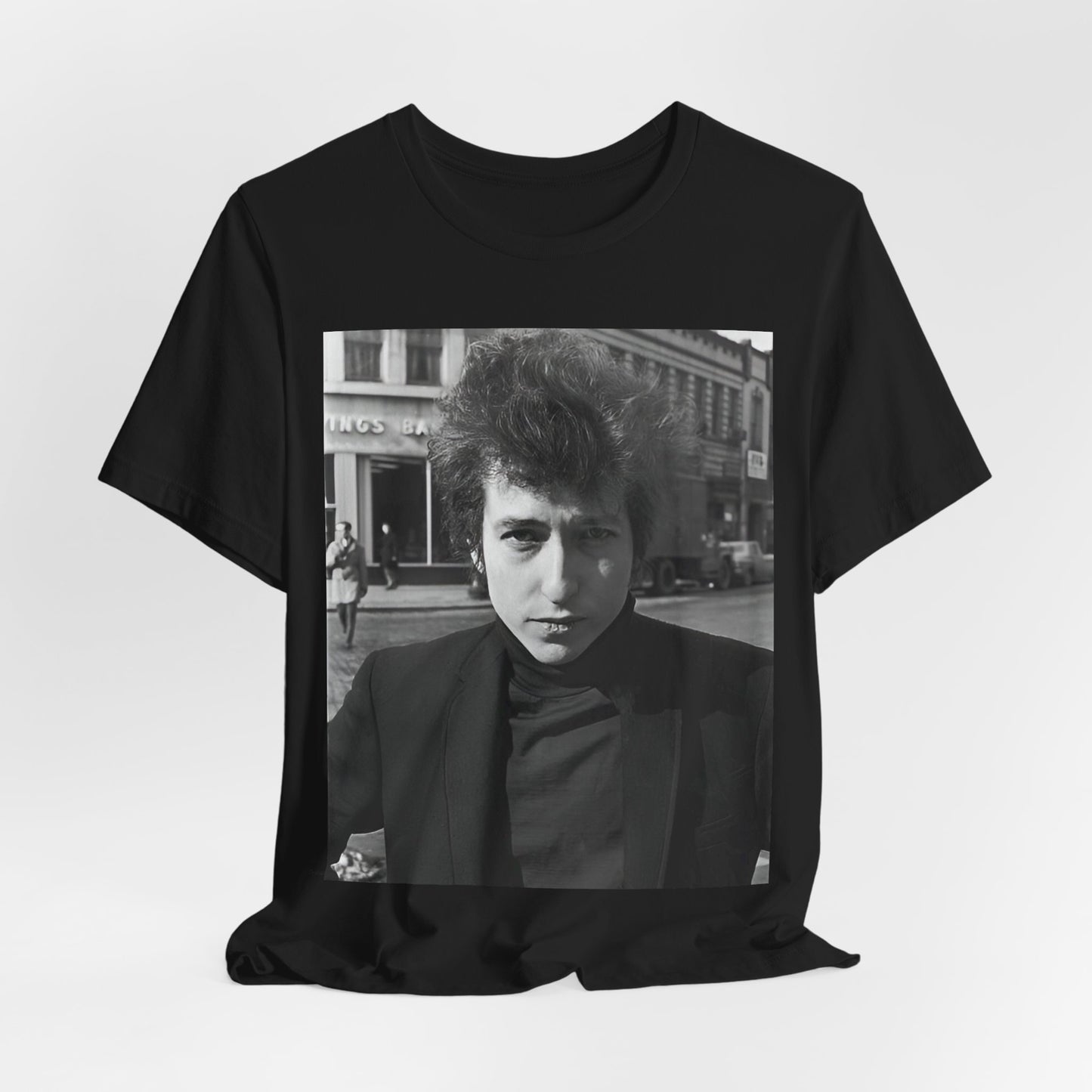 A black graphic t-shirt featuring a 60s black and white photo portrait of Bob Dylan.