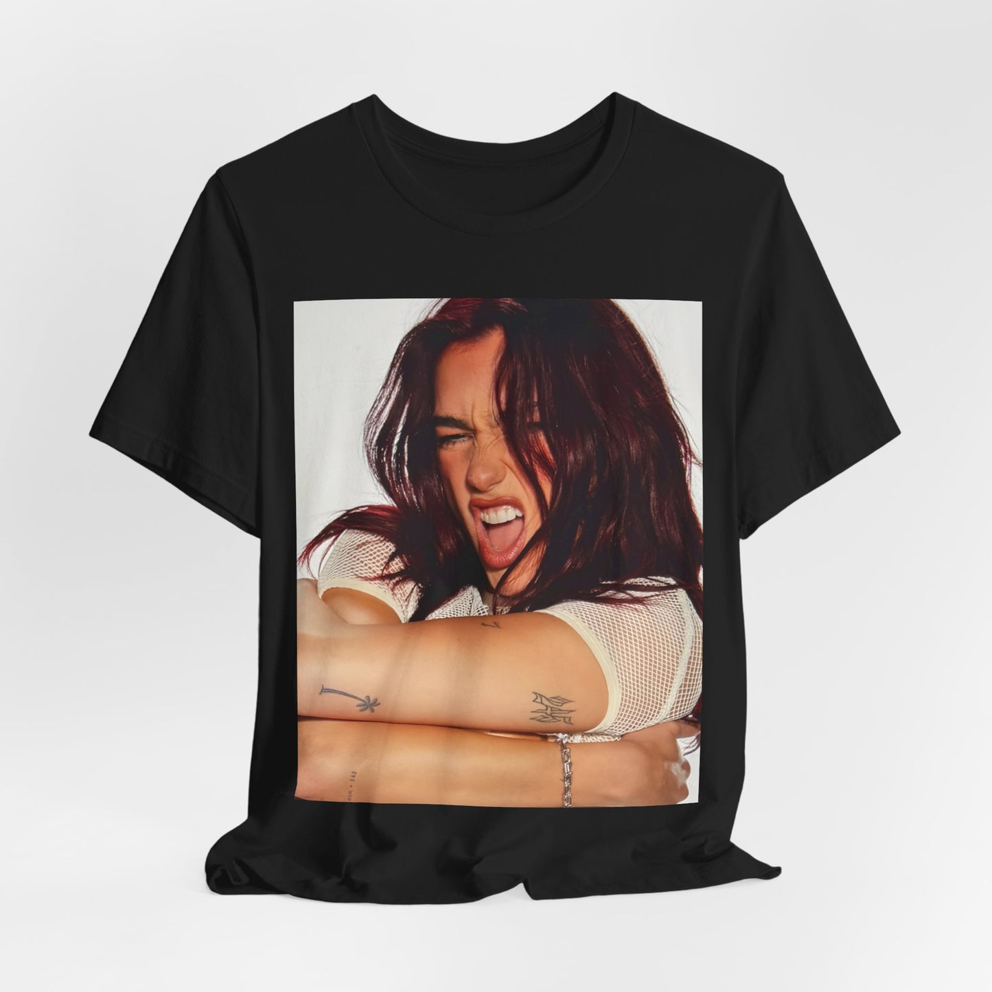 A black graphic t-shirt featuring a bold disco pop graphic of Dua Lipa as a superstar.