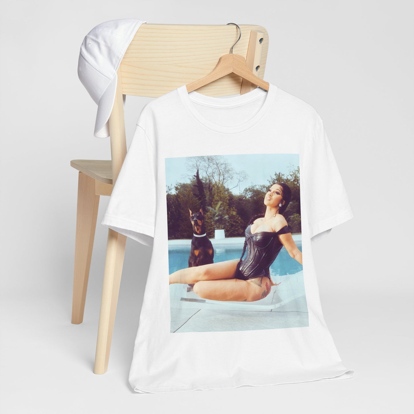 A black graphic t-shirt featuring a graphic related to Cardi B's 'I Like It' song, with bold pop culture elements.