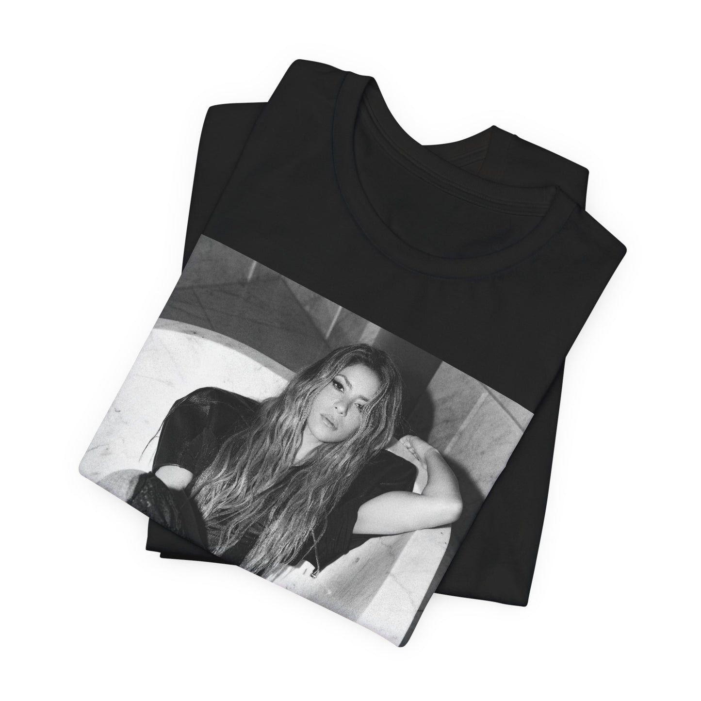 A black graphic t-shirt featuring a retro graphic related to Shakira's 'Hips Don't Lie' song or era.