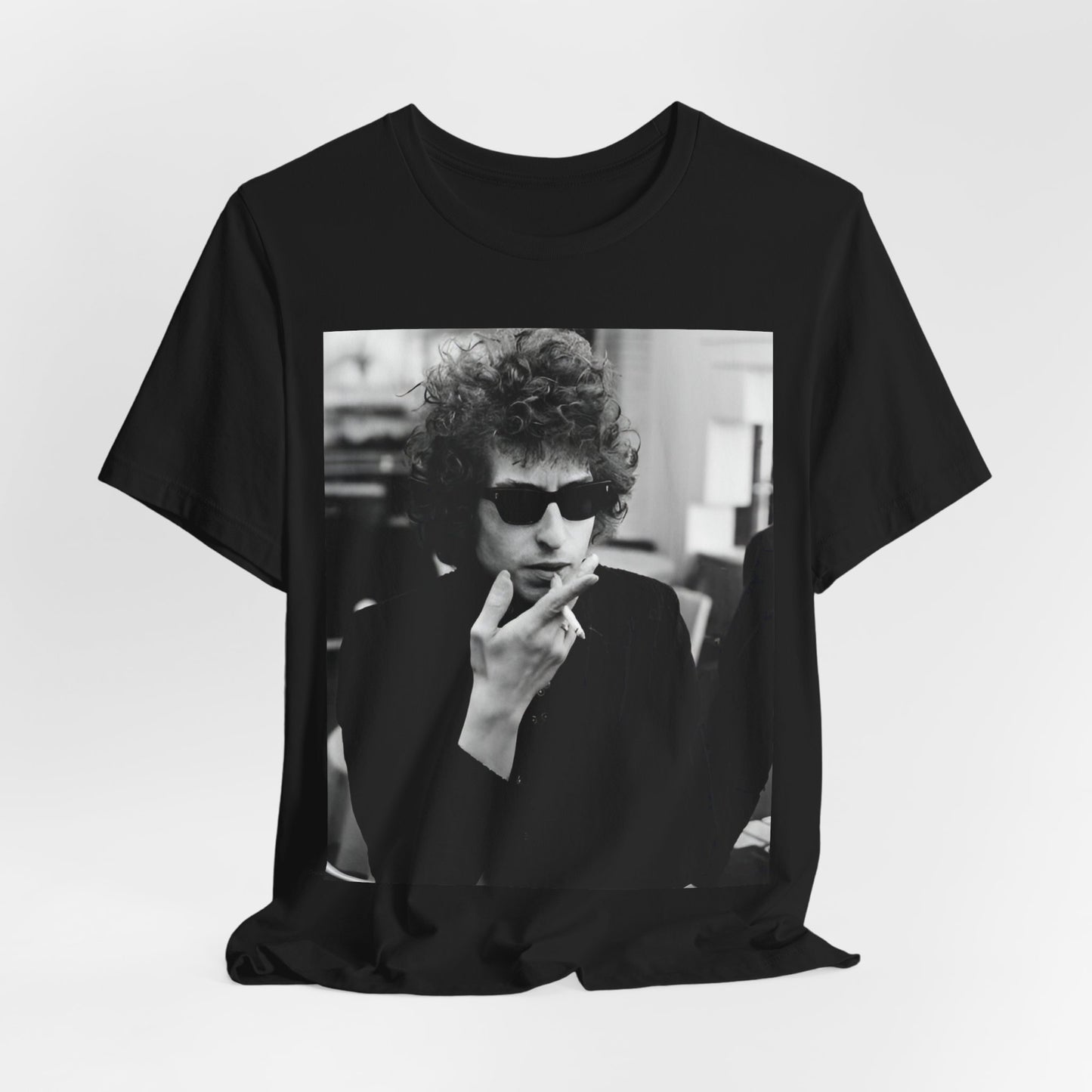 A black graphic t-shirt featuring a retro black and white graphic of Bob Dylan in a rebellious pose.