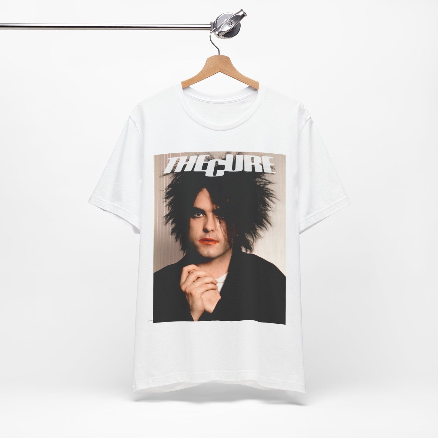 A black graphic t-shirt featuring a 90s portrait photo of Robert Smith from The Cure.