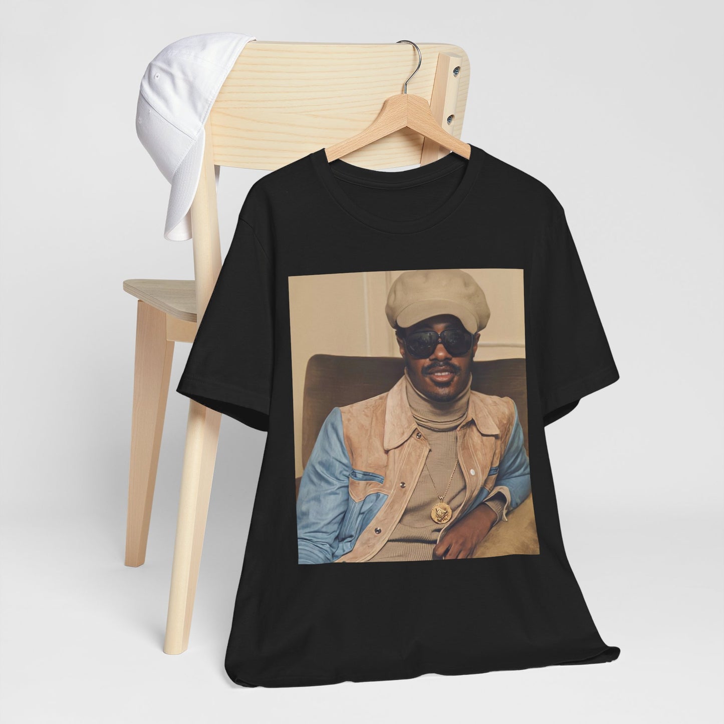 A black graphic t-shirt featuring a retro graphic related to Stevie Wonder's 'Songs in the Key of Life' album era.