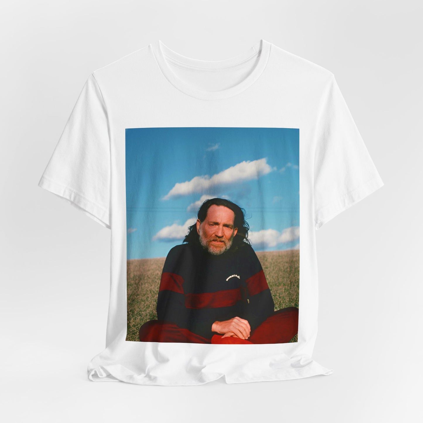 A black graphic t-shirt featuring a classic outlaw country graphic of Willie Nelson.